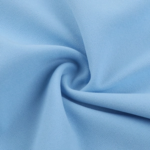 Detailed macro view of light blue chiffon fabric texture and soft drape of the dress