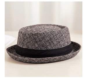 Detailed view of woven gray and black pattern texture and black ribbon on fedora hat