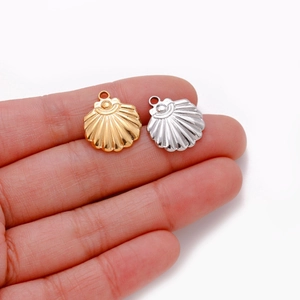 Detailed close-up of gold and silver shell pendants for DIY jewelry making