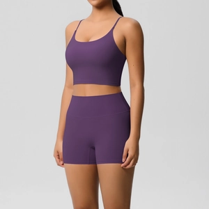 Detail of dark purple yoga set featuring thin straps and high-waist stretch compression shorts