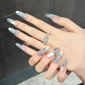 Blue butterfly almond press-on nails with silver glitter gradient and 3D rhinestones