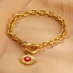 Detail of 18k gold plated chain bracelet with enamel evil eye charm and OT toggle clasp