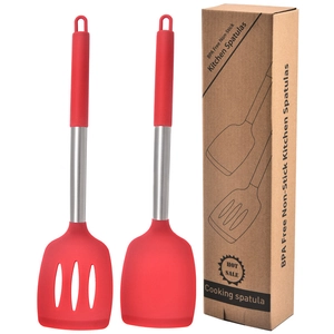 Detail of red silicone spatula and slotted turner set with stainless steel handles