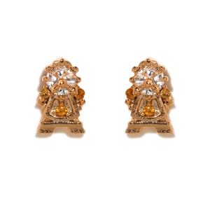 Detailed close-up of golden tea-themed stud earrings featuring clear and orange zircons