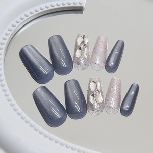 Blue cat-eye press-on nails in long coffin shape with silver glitter and stone accents