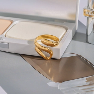 Luxurious gold stainless steel fluid wrap ring with elegant modern polished finish