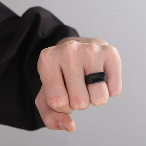 Close-up of minimalist black square signet ring in polished stainless steel for men