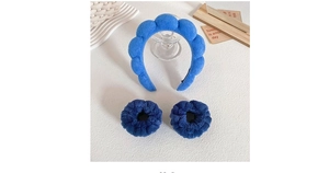 Close-up of blue plush headband and wristband set for face washing and makeup routines