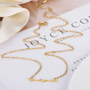 Minimalist gold stainless steel mama pendant necklace for women on white silk background
