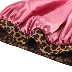 Pink satin hair bonnet with leopard print elastic band for beauty and hair care