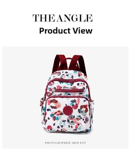 Detailed front view of nylon backpack with abstract ink print and maroon straps