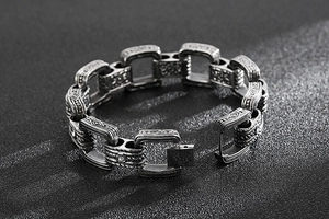 Détails macro des gravures géométriques sur le bracelet à maillons en acier inoxydable