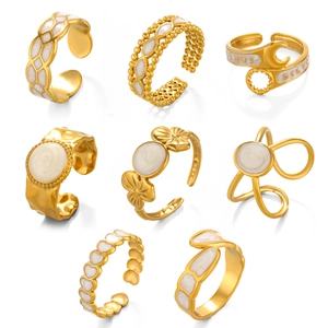 Set of eight gold-plated open rings with white enamel and geometric heart designs