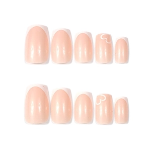 Minimalist white French heart press-on nails with nude pink base and sweet design