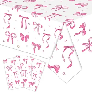 Close-up of pink bow and star pattern on disposable party tablecloth and napkins