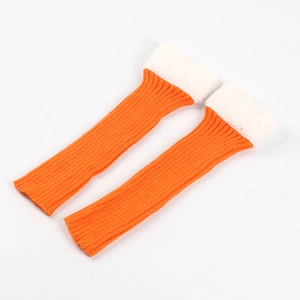 Close-up of orange knitted leg warmers featuring white faux fur cuffs on a white background