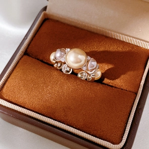 Macro shot of vintage round pearls and zircon inlay on a classic luxury gold ring band