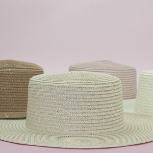 Flat top boater hats in beige, camel, pink, and ivory with fine woven straw texture