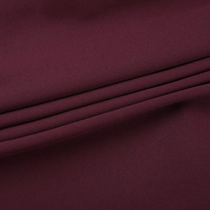 Macro shot of deep burgundy yoga set fabric showing smooth knit texture and flexibility