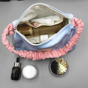 Detailed interior of corduroy cosmetic bag in light blue and pink with zipper