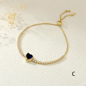 Close-up of adjustable copper heart bracelet with blue gemstone and micro-pave crystals