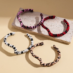 Retro animal print cuff bracelets with leopard and zebra patterns on stone base