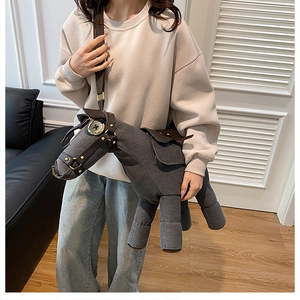 Detailed view of a quirky donkey shaped canvas shoulder bag worn by a model