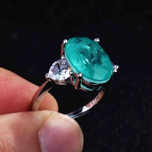 Detail view of pear-cut side stones and oval turquoise gemstone on silver ring