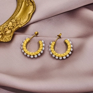 Elegant gold plated stainless steel hoop earrings with small white pearls on satin