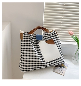 Detailed view of checkered canvas tote bag with brown straps and tulip decor