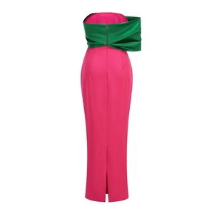 Detail of evening dress back with oversized green satin bow and fuchsia mermaid skirt