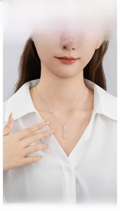 Close-up of a 925 silver crescent moon and star necklace with zircons on a model
