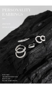 Detail view of S925 sterling silver hoop earrings set with micro zircon on black charcoal