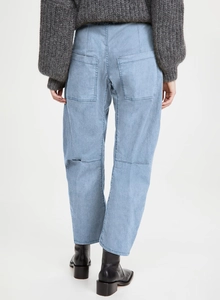 Detail view of high waist denim trousers with rear pocket design and washed finish