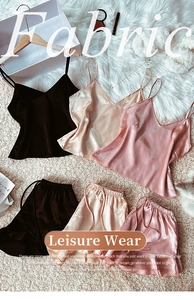 Three silk pajama sets in black, gold, and pink with camisole and ruffled shorts