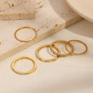 Set of five elegant gold stainless steel rings with minimalist diamond accents on stone