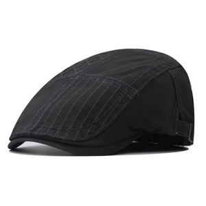 Detail view of adjustable metal buckle and leather strap on a black vintage flat cap