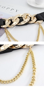 Close-up of elastic waist belt with gold chain buckle and layered drop chain detail