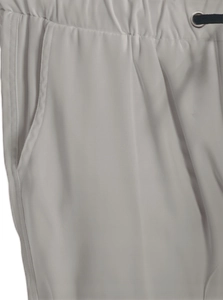 Detail of elastic waist with metal eyelet drawstrings and side pockets on men cargo pants