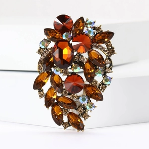 Detailed macro view of vintage bronze brooch with amber crystals and rhinestones