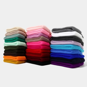Detailed close-up of ribbed knit beanies in various colors and soft texture