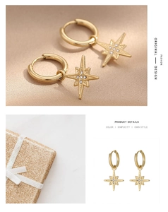 Detail of gold-plated star earrings with embedded rhinestones on soft satin background
