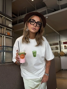 Women's oversized white cotton T-shirt featuring a green matcha latte print and lettering