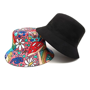 Double-sided bucket hat featuring a solid black side and colorful mushroom daisy print