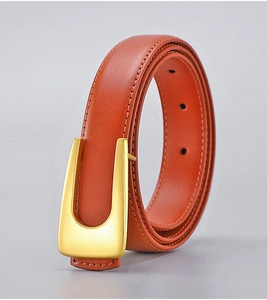 Detail view of brown leather belt with matte gold U-shaped metal buckle and neat stitching