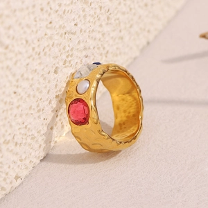 Detail of 18K gold plated stainless steel ring with hammered texture and colorful gemstones