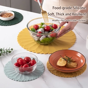 Modern petal-shaped silicone heat resistant placemats in yellow, blue and dark green