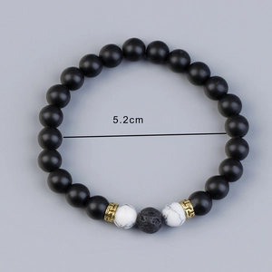 Lava stone bead bracelet with 5.2cm inner diameter detail on plain gray background