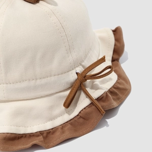 Dual-tone baby sun hat with cherry accent, ruffle brim and decorative brown bow detail