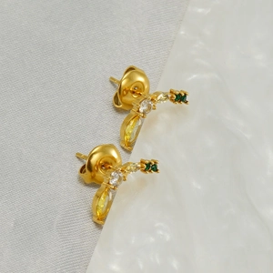 Fashionable banana stud earrings in gold stainless steel with yellow and green crystals